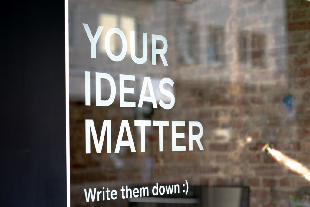 quote on window saying your ideas matter write them down