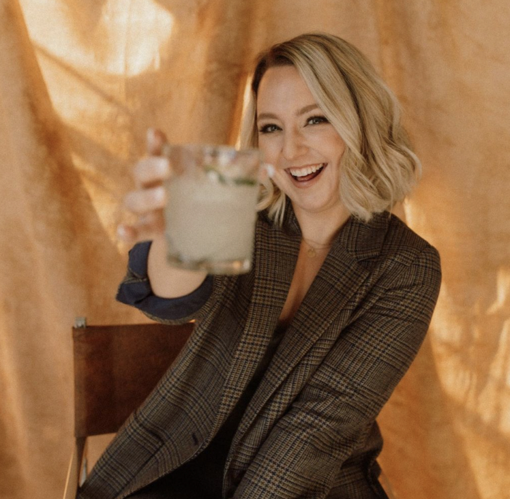Headshot of Sarah Brookhart cheersing with a margarita used in a copywriting example case study
